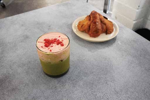 Matcha strawberry cream latte on a café table