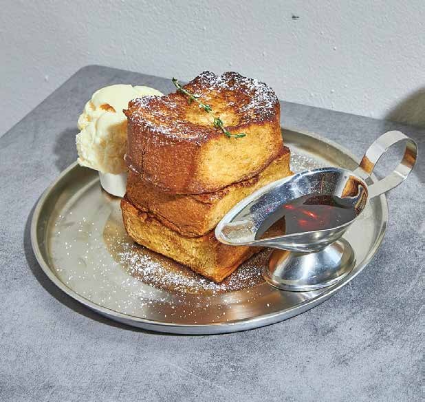 French toast with ice cream and syrup on a silver plate